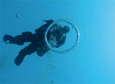 Technical diver blowing an air ring in Malta